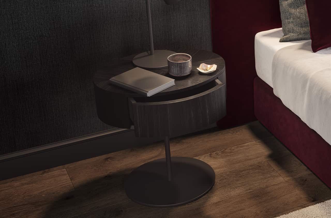 Kompakt und elegant verbindet der runde Nachttisch dunkles Holz mit moderner Leichtigkeit.